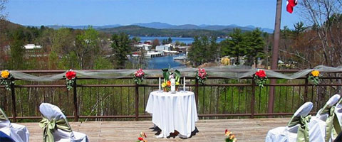A wedding kiss with a backdrop of lakes and mountains.